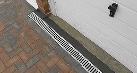 Strip trench drain along a paver driveway in Jacksonville